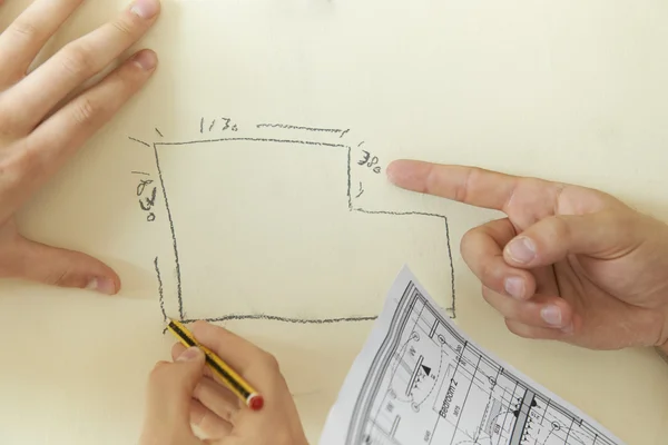 Builders Looking At Hand Drawn Plan On Wall — Stock Photo, Image