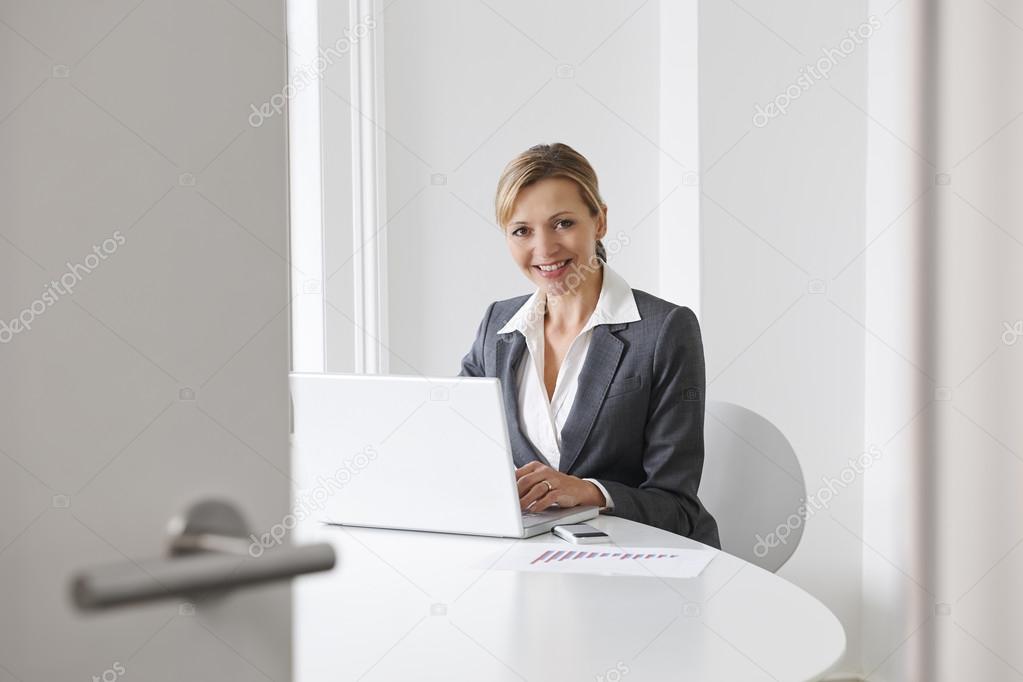 Businesswoman Preparing For Meeting In Boardroom