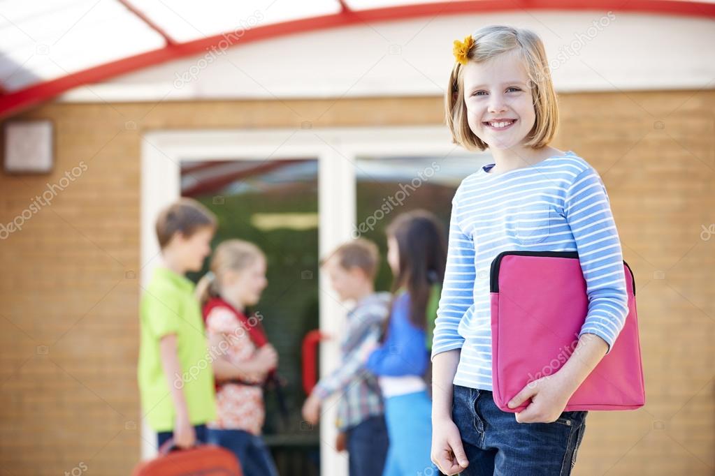 Girl Standing Outside School With Book Bag