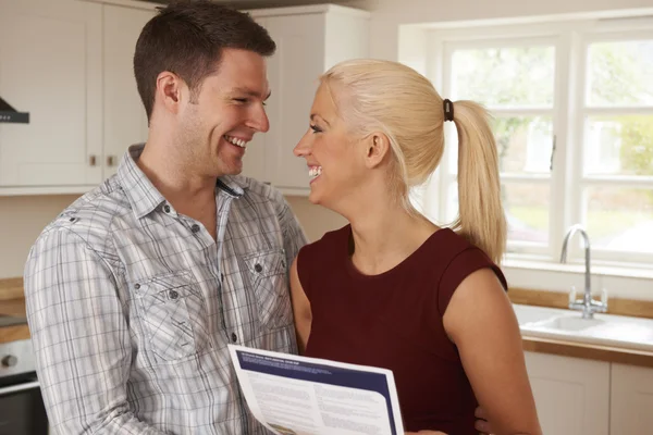 Young Couple Looking At Details For New Home — Stock Photo, Image