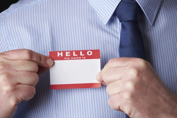 Businessman Attaching Name Tag At Conference — Stock Photo, Image