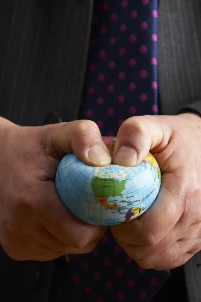 Businessman Squeezing Globe Over North America — Stock Photo, Image