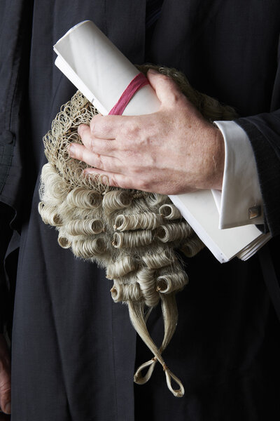 Close Up Of Barrister Holding Brief And Wig