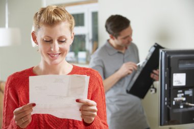 Happy Woman Looking At Bill For TV Installation clipart