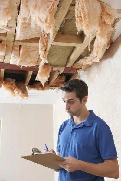 Constructeur préparant le devis pour la réparation au plafond — Photo