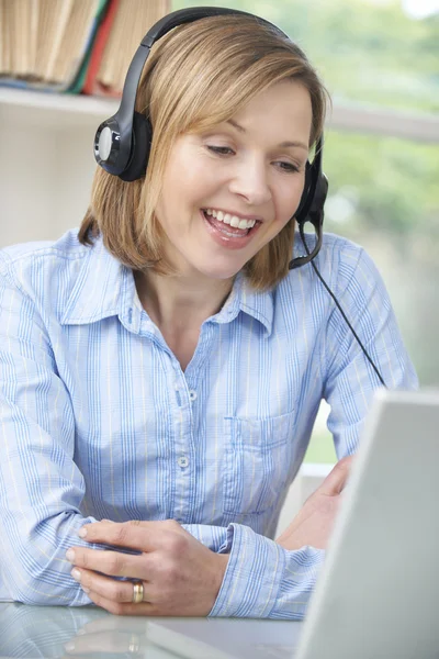 Mulher falando on-line usando fone de ouvido — Fotografia de Stock