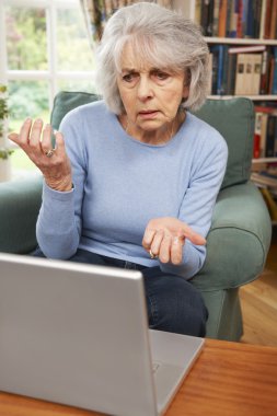 Frustrated Senior Woman Using Laptop clipart