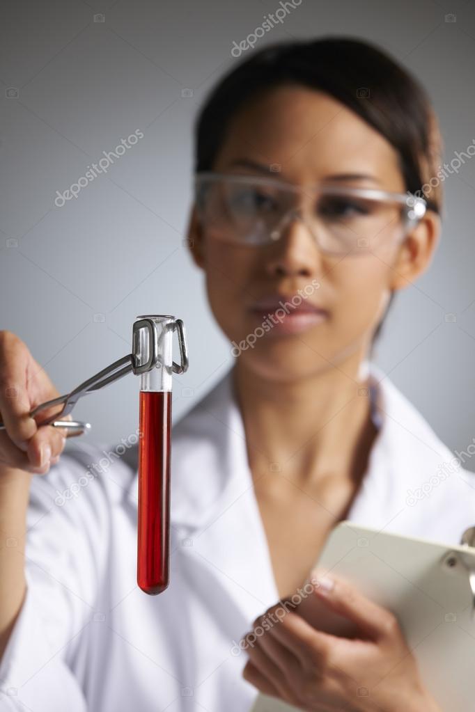 Female Scientist Examining Test Tube