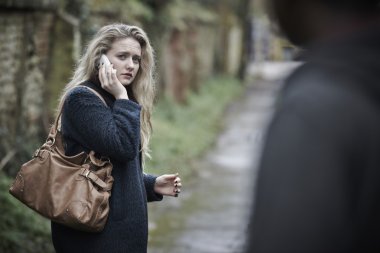 Teenage Girl Feeling Threatened As She Walks Along Path clipart