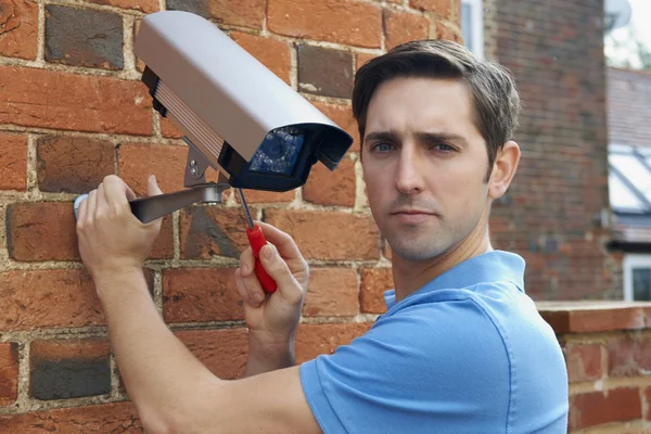 Man Fitting Security Camera To House — Stock Photo, Image