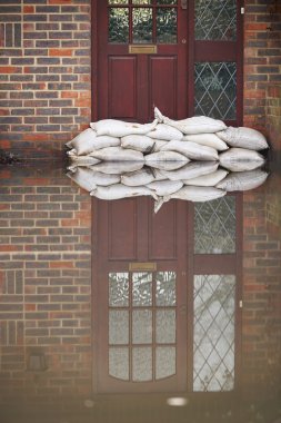 Sandbags Outside Front Door Of Flooded House clipart