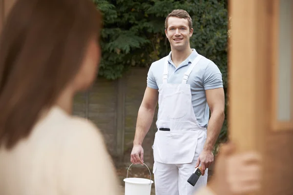 Woman Opening Door To Decorator — Stock Photo, Image