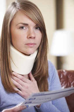 Young Woman Wearing Neck Brace Reading Letter clipart