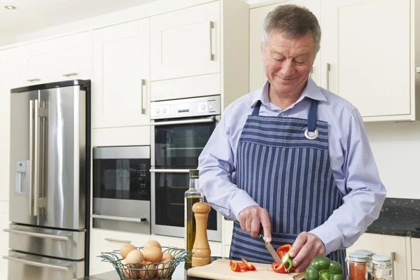 Uomo anziano che prepara il pasto in cucina — Foto Stock