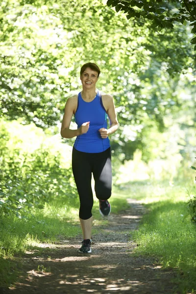 Middle Aged Woman Running In Countryside — Stock Photo, Image
