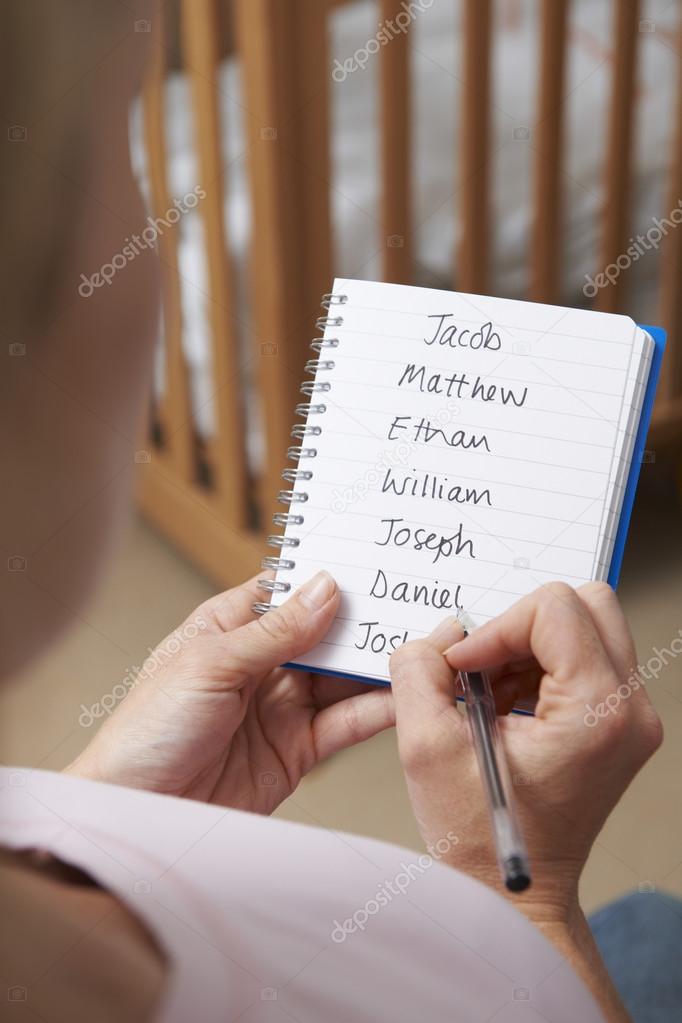 Woman Writing Possible Names For Baby Boy In Nursery