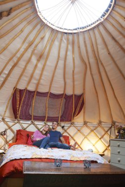 Couple Enjoying Luxury Camping Holiday In Yurt clipart