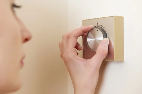 Woman Adjusting Central Heating Thermostat Control — Stock Photo, Image