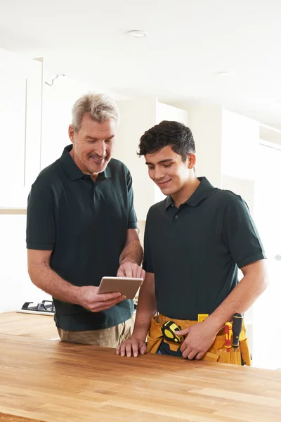 Timmerman en leerling met digitale Tablet passend luxe Kitc — Stockfoto