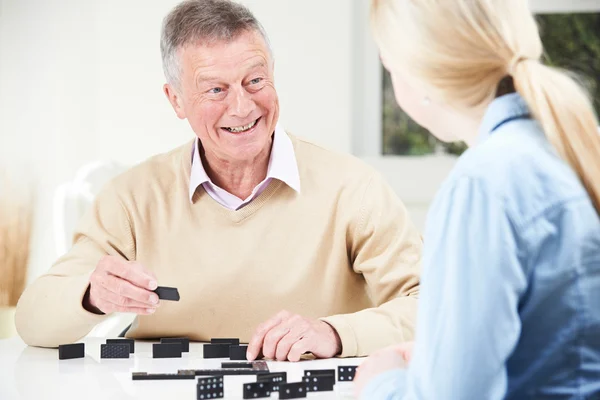 Senior Man Playing Dominoes With Teenage Granddaughter — Stock Photo, Image