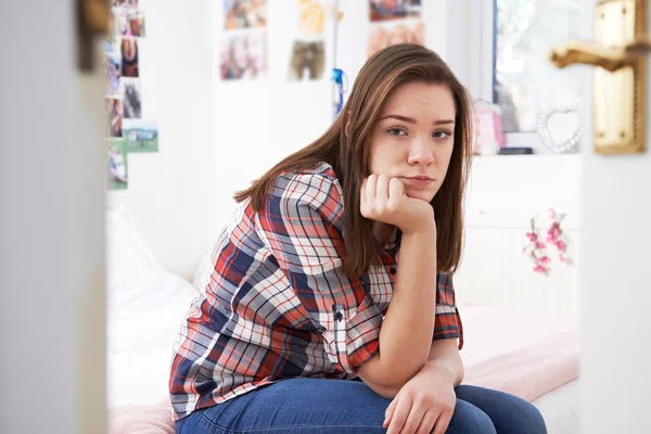 Depresso adolescente ragazza seduta in camera da letto — Foto Stock