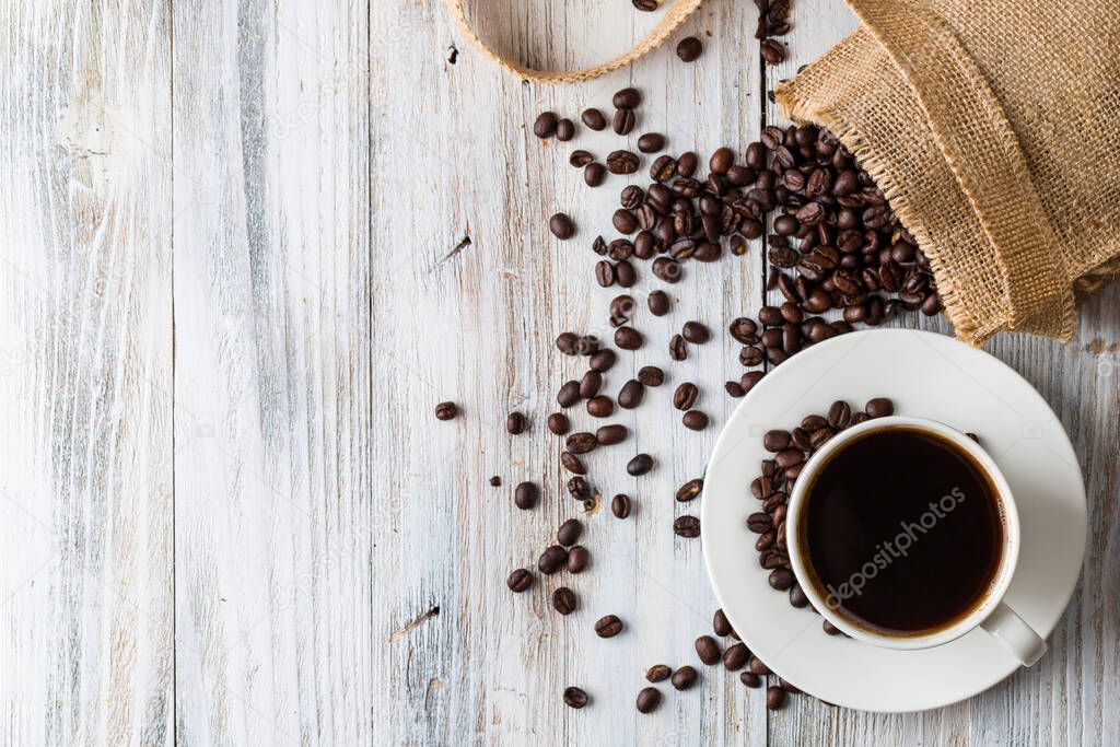 White coffee Cup on light wooden background with copy space