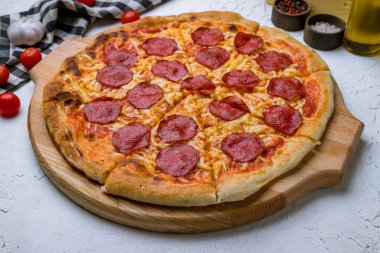 Beyaz beton masada Pepperoni pizza.