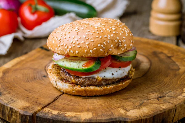 Burger with egg and beef and vegetables