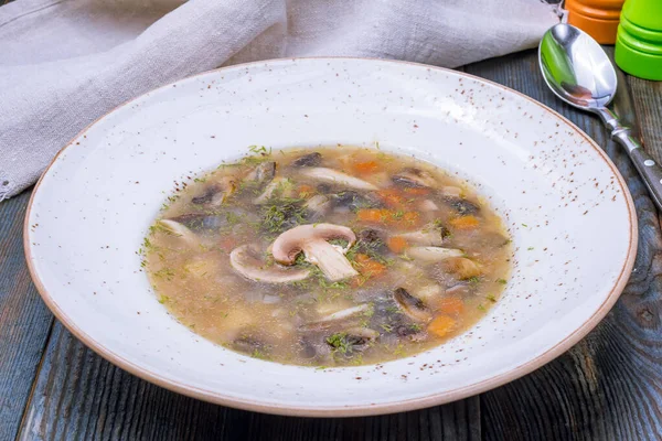 Soup mushroom in a plate on blue wooden table — Stock Image Soup Mushroom Plate Blue Wooden Table Stock Image