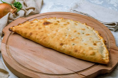 Tahtada kapalı calzone pizza. 