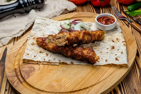 stock image Lamb Lula kebabs with sauce on wooden background