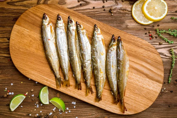cold smoked vendace fish on wooden board