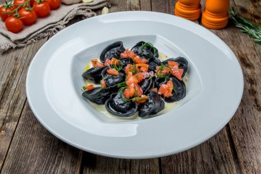 black ravioli with crab