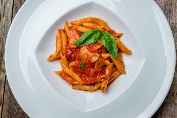 delicious Pasta Penne arabiatan in white bowl