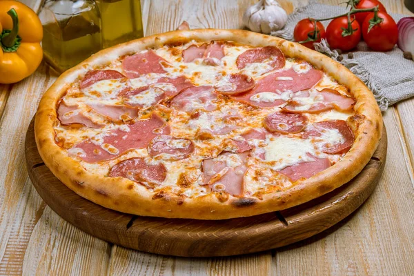 Italian meat pizza on wooden table
