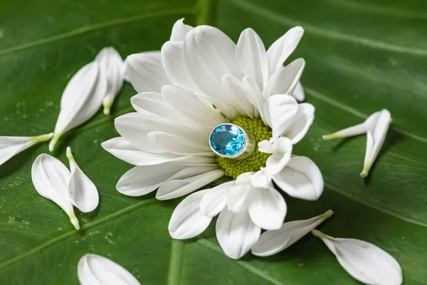 Fashion silver or white gold ring with a blue oval aquamarine stone.