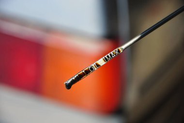 Arabanın motorundaki yağ seviyesini kontrol etmek için dipstick. Bulanık arkaplan