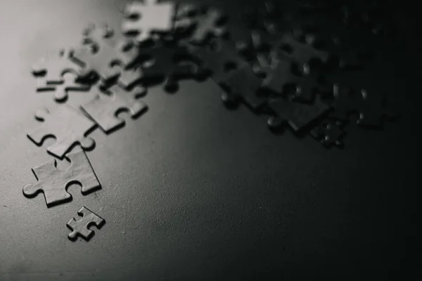 Photo of black puzzles on a black background, business background