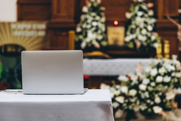 liturgy during the epidemic: a laptop with a webcam is sent to the altar where the liturgy will be sent for live broadcast