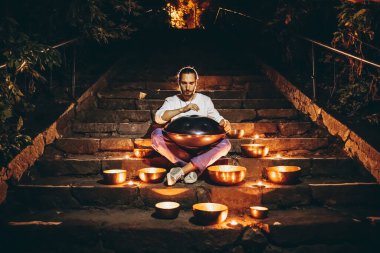 Tibet şarkı kaseleri ve yanan mumlarla çevrili bir adamın silueti gece şehrinin merdivenlerinde oturuyordu. Film üzerinde gürültü etkisi