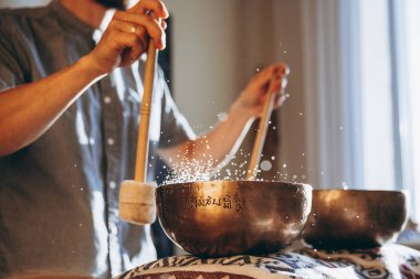 Masörlü bir spa ve Tibet müzik kaseleriyle rahatlatıcı bir masaj yapan bir müşteri.