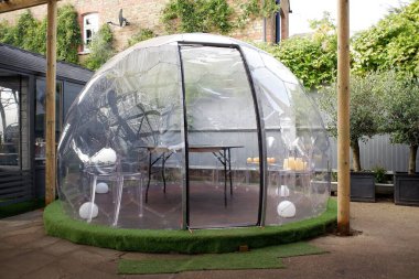 Plastic igloo dome tent used to dine outside pub during the Coronavirus (Covid-19) pandemic clipart