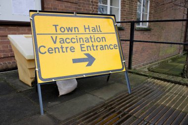 Covid-19 Town Hall Vaccination Centre direction sign clipart
