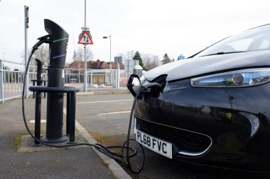 Ubeeqo hire vehicle at electric charging point at Watford Town Hall car park clipart