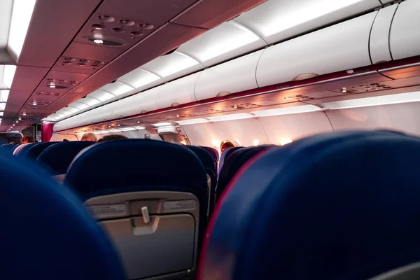 Soft focus background of the interior of commercial empty airplane seats. Copy space.