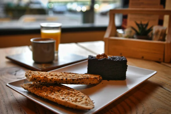 Chocolate brownie. breakfast with brownie, toast, coffee and orange juice.