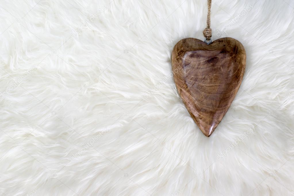 Wooden heart on white fur