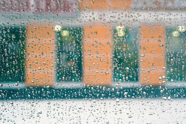 Bulanık bir binanın arka planındaki arabanın camına düşer.