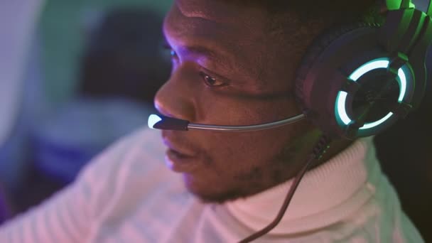 Fekete férfi, üzletember fülhallgatóval, otthonról dolgozik. Online támogatás — Stock videók