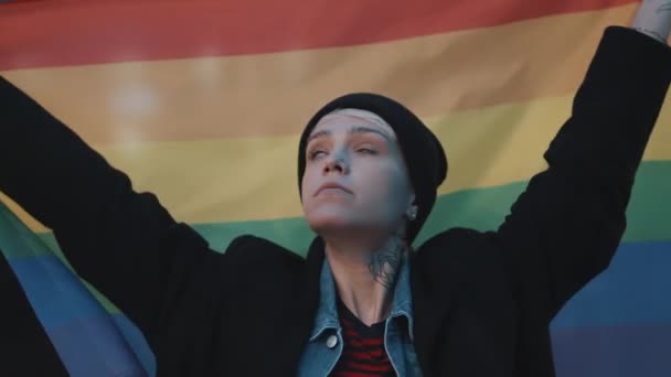 虹の旗を持つ若い女性。性的指向の受容のための戦いの概念 — ストック動画